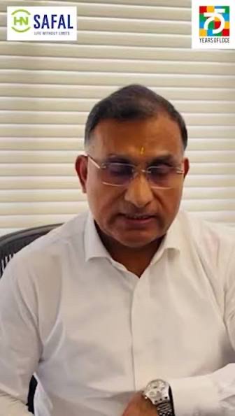 Dhiren Vora in a white shirt speaking in a video message, HN Safal and LDCE 75 logos visible